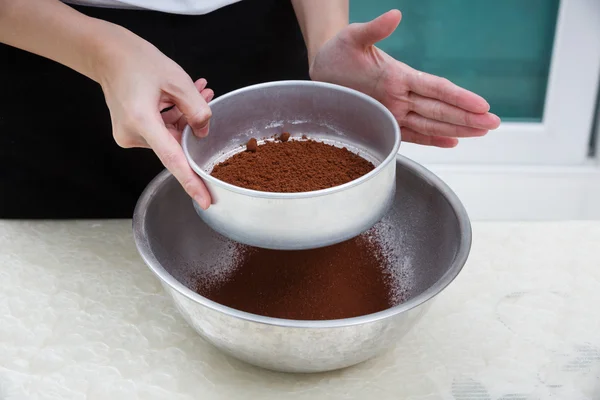 Sifting cocoa powder — Stock Photo, Image