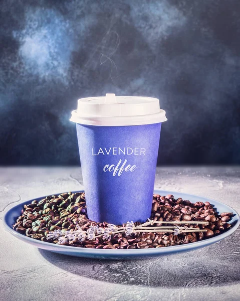 Vertical blurred coffee composition with a coffee to go cup of hot lavender latte with steam on coffee beans on a dark blue background. The concept of delicious coffee to take away