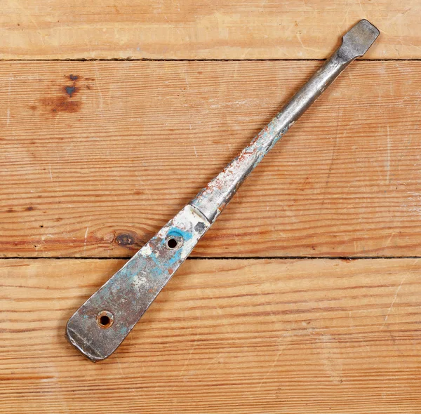 Old screwdriver lying on wooden boards. No body. — Stock Photo, Image