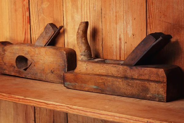 Two planes on the wooden shelf, on a wall from boards. — Stock Photo, Image