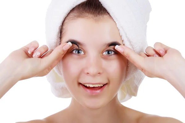 Young girl in a towel after a shower with braces, trying on eyelashes. — Stock Photo, Image