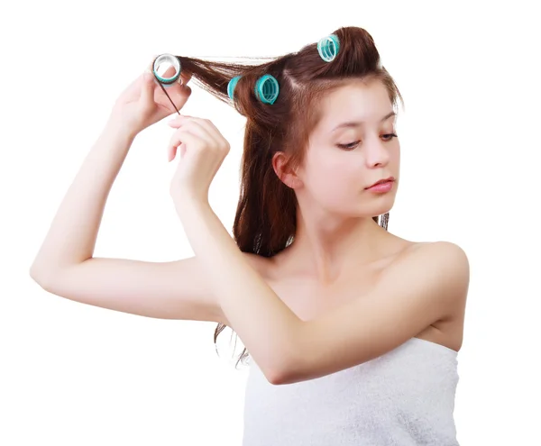 Close up portrait of Young beautiful girl having hair curlers on her head isolated on white background — Stock Photo, Image