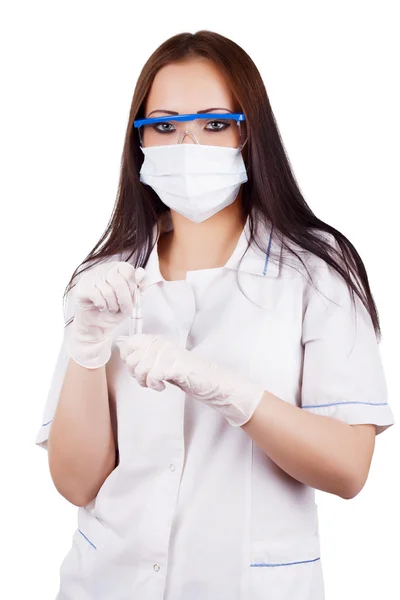 Woman doctor in a mask, goggles and rubber gloves holding capsules Stock Photo