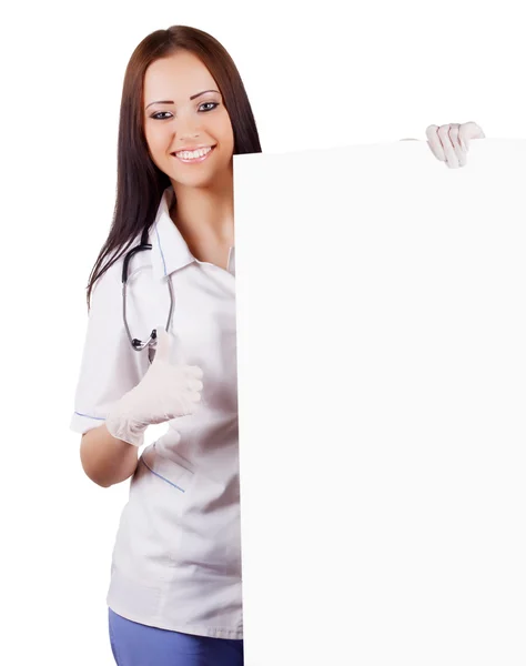 Smiling woman doctor with a banner. Isolated. — Stock Photo, Image