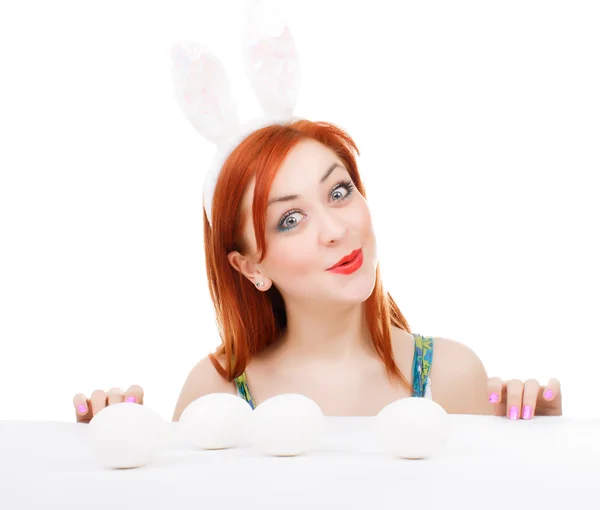 Easter bunny female looking over table for easter eggs — Stock Photo, Image