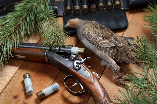 Hunting trophy - partridge, rifle, cartridge belt, ammunition, on wooden boards — Stock Photo, Image