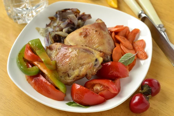 Baked chicken thigh with roasted vegetables — Stock Photo, Image