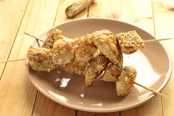 Chicken skewers in sesame breading — Stock Photo, Image