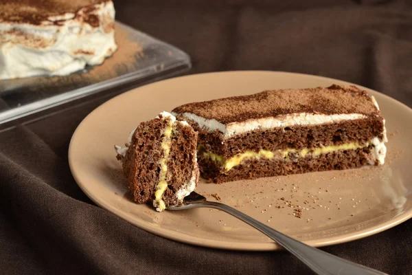 Chocolate sponge cake with lemon cream and whipped cream — Stock Photo, Image