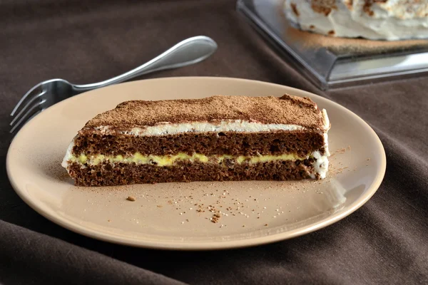 Chocolate sponge cake with lemon cream and whipped cream — Stock Photo, Image