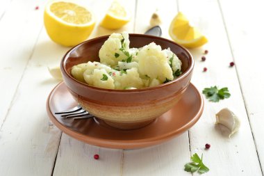 Cauliflower with garlic and parsley in lemon sauce clipart