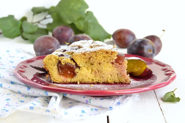 Slice of cake from corn meal with plums — Stock Photo, Image