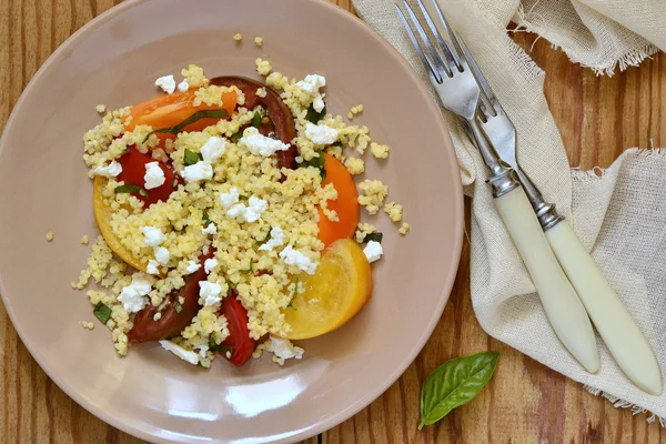 Millet with basil and fresh tomatoes and goat cheese — Stock Photo, Image