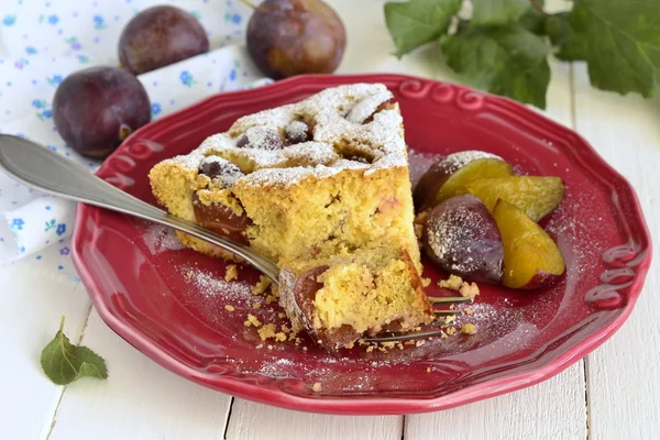 Slice of cake from corn meal with plums — Stock Photo, Image