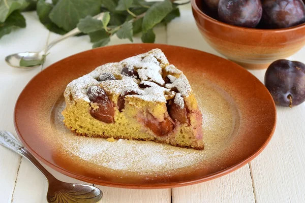 Slice of cake from corn meal with plums — Stock Photo, Image
