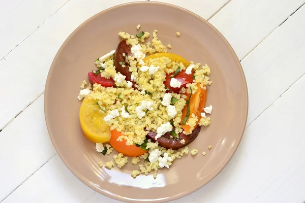 Millet with basil and fresh tomatoes and goat cheese — Stock Photo, Image