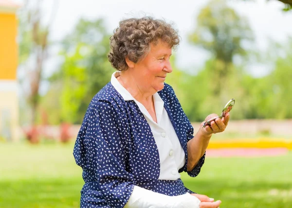 Trendy grandmother using her mirror — Stock Photo, Image