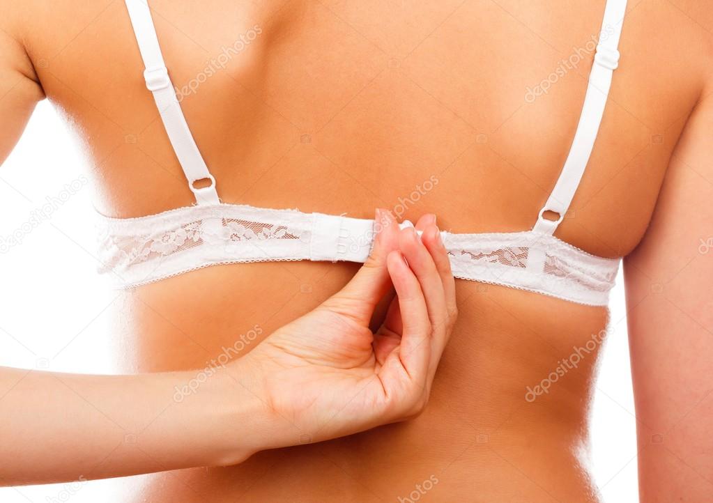 Midsection of woman unhooking bra