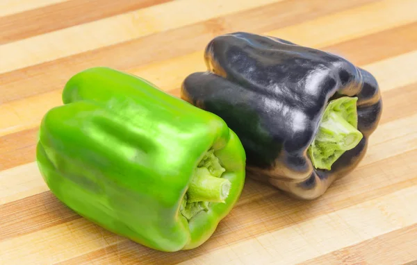 Fresh Black and green Bell pepper on a cutting board — Stock Photo, Image