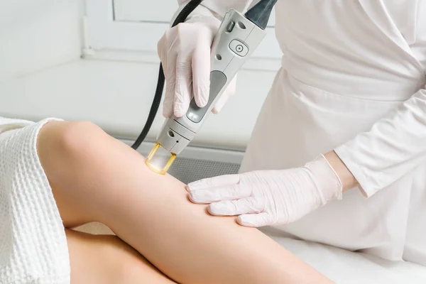 Kozmetik kliniğinde bir kadının vücudundaki kılların alınması prosedürü. Lazer tüy dökücü.. — Stok fotoğraf