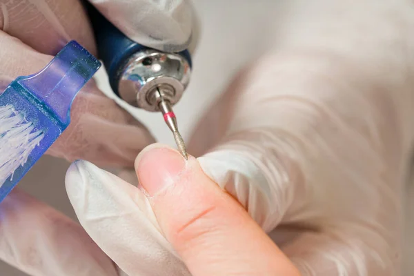 Femme dans un salon de manucure recevant une manucure par un esthéticienne avec lime à ongles. Beauté et soin des mains close-up. — Photo