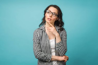 Portrait of a thoughtful young woman solving a difficult problem