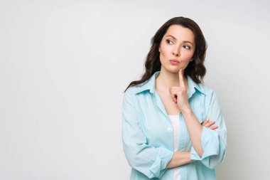 Portrait of a thoughtful young woman solving a difficult problem