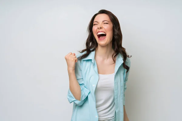 A happy, excited woman, rejoices at the good news, actively gestures with happiness. Royalty Free Stock Images