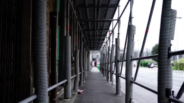 Scaffolding at building construction protecting sidewalk — Stock Video