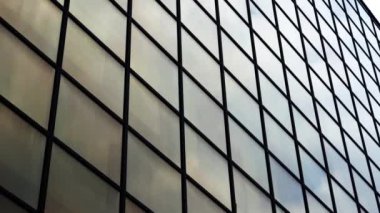Modern business center mirror windows with reflected clouds
