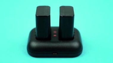 Black portable battery charger with red flashing lights