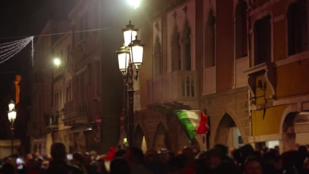 Multitud de personas con banderas italianas protestan en la calle oscura — Vídeos de Stock