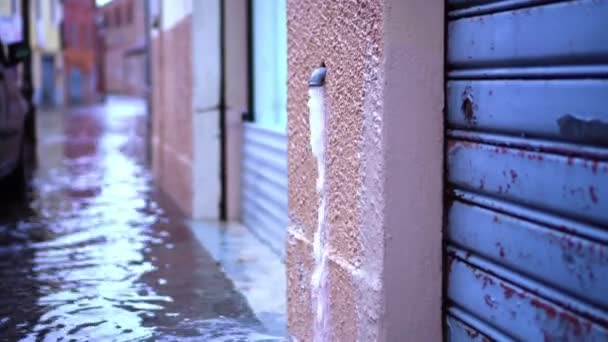 Water stroomt in het Italiaans Aqua Alta uit kleine afvoerpijp — Stockvideo