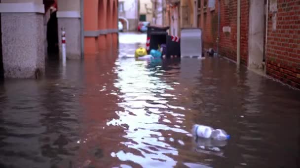 Plastic bottles and trash float on high flood water surface — Stock Video