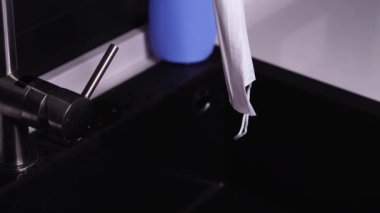 Yıkanmış beyaz koruyucu tıbbi maske lavaboda asılı.
