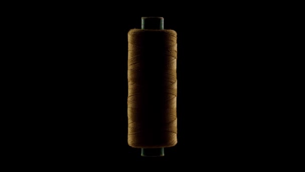 Orange sewing thread on a black background — Stock Video