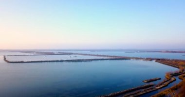 Endless wide calm blue lagoon with small ground islands