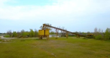 Nehrin yanında çelik konteynırlar ve taşıma bantları var.