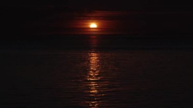 Işıldayan güneş ışığı dalgalı denizde suya yansıma yaratır.