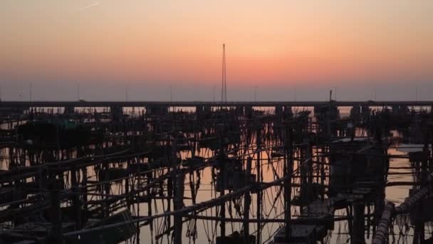 Filets de pêche et des conteneurs signe sur l'eau au coucher du soleil — Video