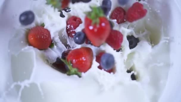 Fruit falls in slow motion into the milk — Stock Video