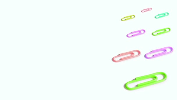 Colorful paper clips spin on white background — Stock Video