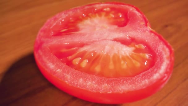 Cut tomato on wooden table — Αρχείο Βίντεο