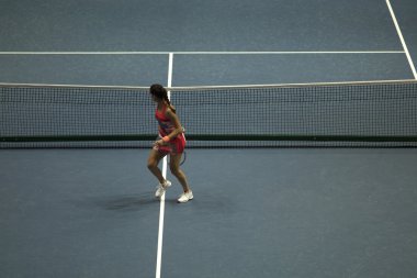 Tenis oynayan genç bir kadın.