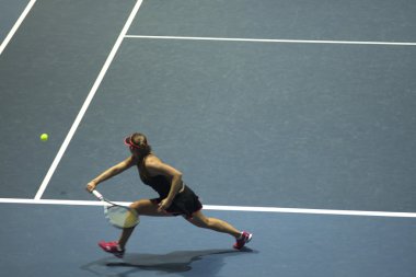 Tenis oynayan genç bir kadın.