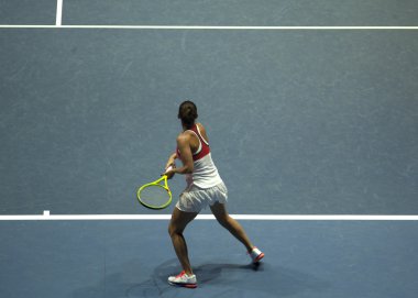 Tenis oynayan genç bir kadın.