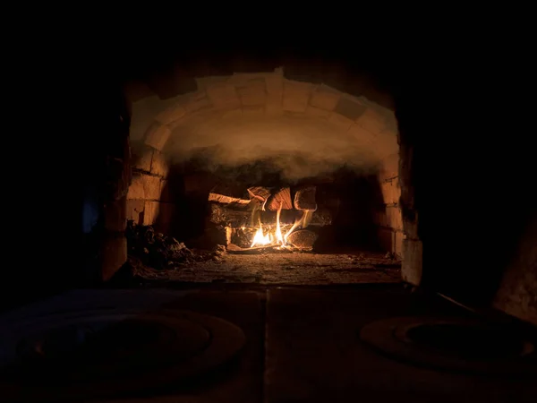 Russian interior oven with an oven and a burning fire, covered with texture