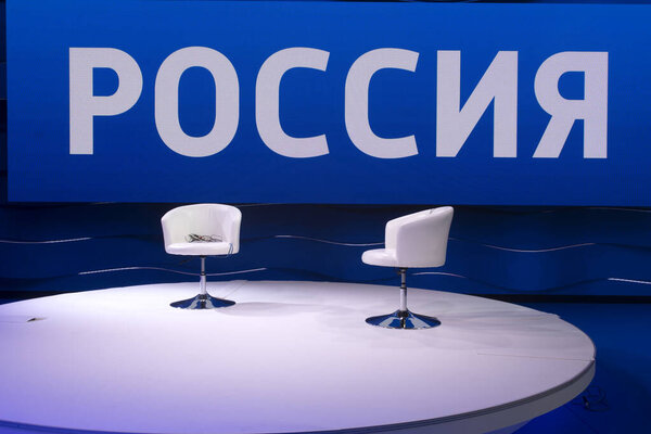 two white chairs in a television studio, large inscription RUSSIA.