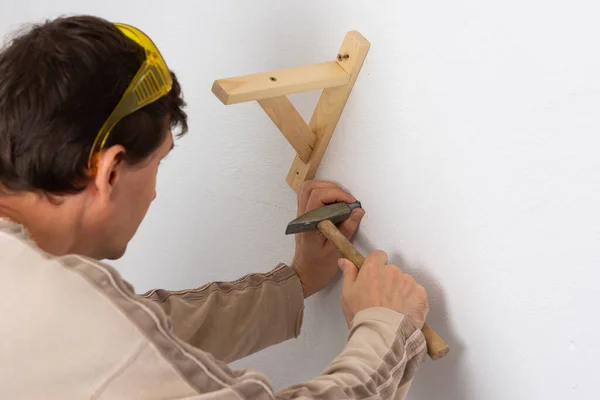 Man Hangs Shelf Apartment White Wall Worker Scores Plastic Anchor — Stock Photo, Image