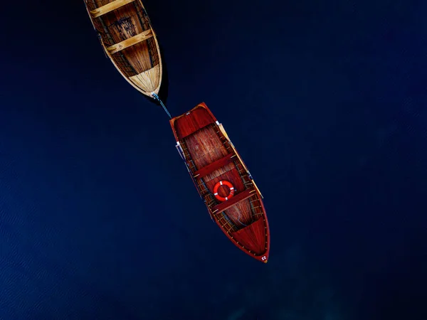 Derin mavi sularda yüzen iki güzel tekne dingin ve büyüleyici bir doğal manzara yaratır.